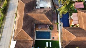 an overhead view of a building with a pool at Nana's Bar & Hotel in Nong Prue