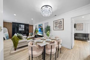 a living room with a table and chairs at Entire Private House with King Bed, 80 TV, Gated Yard, Ranch Style, 4 Bedrooms 2 Bathrooms, Available Now in El Cajon