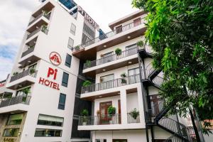 an apartment building with potted plants on balconies at Pi Hotel Phố cổ Hoa Lư in Kỳ Vĩ