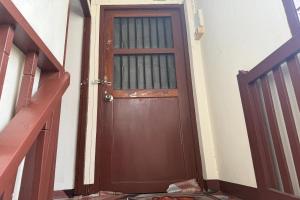 a wooden door in a hallway next to a staircase at Sleep Break Hostel Sathon in Bangkok +33 photos