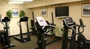 a gym with cardio equipment and a flat screen tv at Flagstaff Hotel in Flagstaff