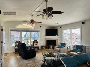 a living room with a couch and a fireplace at Beach Ya There in Holden Beach