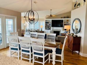 a dining room and living room with a table and chairs at The Seventh Day in Holden Beach