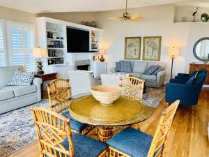 a living room with a table and chairs at The Seventh Day in Holden Beach