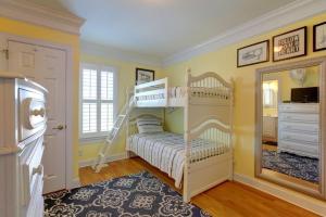 a bedroom with two bunk beds and a mirror at The Seventh Day in Holden Beach +29 photos