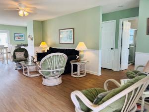 a living room with a couch and chairs at Tradewinds in Holden Beach
