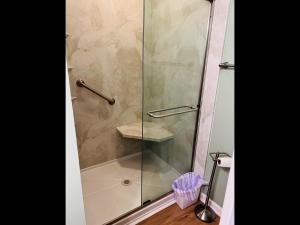 a shower with a glass door in a bathroom at Tradewinds in Holden Beach