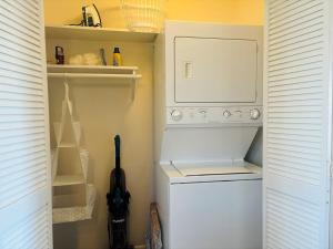 a white washer and dryer in a small room at Plan Beach home in Holden Beach