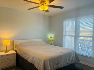a bedroom with a bed and a ceiling fan at Plan Beach home in Holden Beach +33 photos