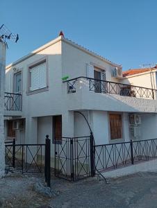 a white house with a balcony on top of it at Zarakas home in Monemvasia