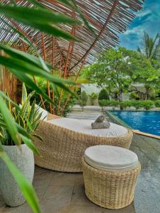 a resort with a pool and wicker chairs and a table at Home Escape Resort in Phumĭ Bát Tráng (2)