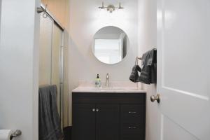 a bathroom with a sink and a mirror at Nautilus Home in Holden Beach