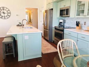 a kitchen with blue cabinets and a counter top at Holden Hideaway condo in Supply