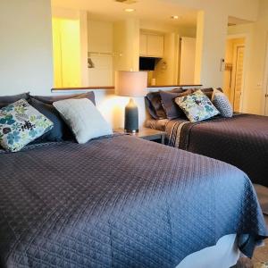 a living room with two beds and a couch at Holden Hideaway condo in Supply +42 photos