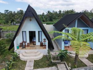 a small house with a black roof at Lombok Grace Bungalows in Tetebatu