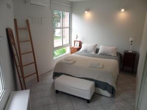 a bedroom with a bed and a ladder and a window at Quinta Un Sueño Junin in Junín +23 photos