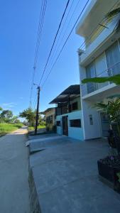 a white building with a pole in front of it at Amazonas magic in Leticia
