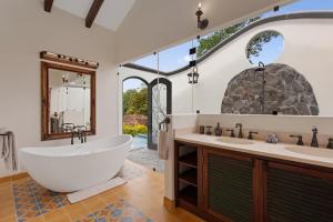 a bathroom with a large tub and two sinks at El Lugar Hotel & Nature Reserve Costa Rica in Tigre