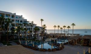 a view of a resort with a pool and palm trees at ME by Meliá Cabo - Adults Only in Cabo San Lucas