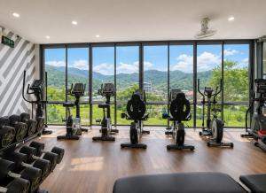 a gym with chairs and a view of the mountains at Oasis in CityGate 1BR Suite in Kamala Beach