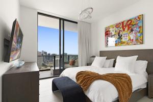 a bedroom with a large bed and a large window at Luxury Penthouse Best Price ,Breathtaking Balcony Views, Ocean & City, Resort Pool, Spa, Gym, in Miami