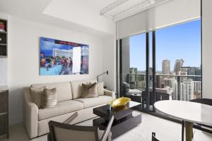 a living room with a couch and a table at Luxury Penthouse Best Price ,Breathtaking Balcony Views, Ocean & City, Resort Pool, Spa, Gym, in Miami