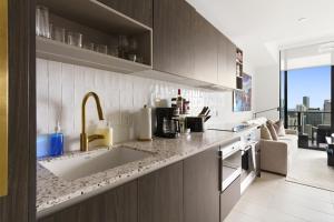 a kitchen with a sink and a counter at Luxury Penthouse Best Price ,Breathtaking Balcony Views, Ocean & City, Resort Pool, Spa, Gym, in Miami +38 photos
