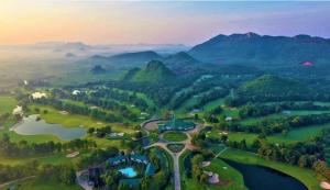 an aerial view of a golf course in the mountains at Riverside Glamping Resort Kanchanaburi in Kanchanaburi City