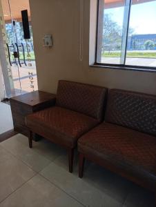 a waiting room with a couch and a table at Hotel Central Cardinal Pedro Juan Caballero in Pedro Juan Caballero