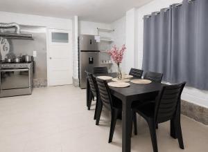 a dining room with a black table and chairs at Riverside Estate with Jacuzzi 9 Bedroom 7 Bath in Baños