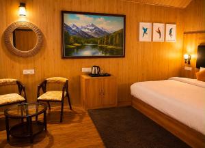 a bedroom with a bed and a table and a mirror at Treehouse by the lake in Bhīm Tāl +33 photos