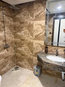 a bathroom with a sink and a mirror at Emanzara in Islamabad