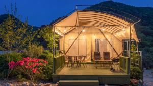 a gazebo with a table and chairs on a deck at Pocheon Terrace 527 Campground in Pocheon +4 photos