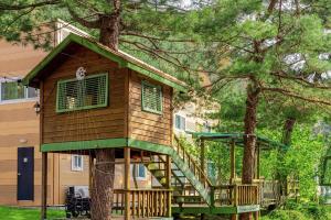 a tree house with a deck and a staircase at Pocheon Terrace 527 Campground in Pocheon