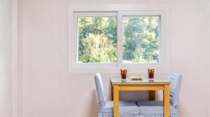 a table with two chairs and a window at Pocheon Terrace 527 Campground in Pocheon
