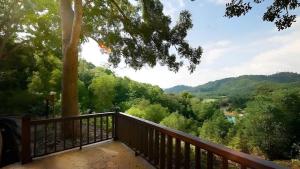 a balcony with a view of trees and a river at Damai Laut Serene Stay Studio Lumut in Lumut