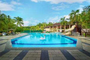 a pool at a resort with a pool slide at Damai Laut Serene Stay Studio Lumut in Lumut
