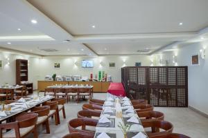a restaurant with tables and chairs in a room at Mithila Yatri Niwas in Janakpur