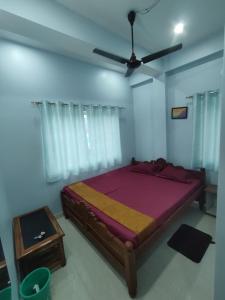 a bedroom with a bed and a ceiling fan at Hotel Namaste Katihar INN in Katihār