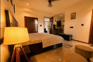 a bedroom with a bed and a lamp at Cozy and Tranquil nest with wifi and homely care in Greater Noida