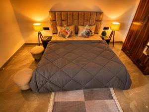 a large bed in a room with two lamps at Cozy and Tranquil nest with wifi and homely care in Greater Noida
