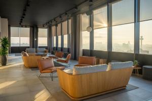 a waiting room with chairs and windows at INNSiDE by Meliá Liverpool in Liverpool