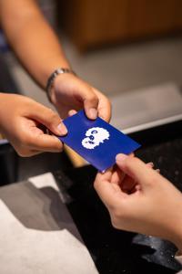a person holding a piece of paper with a skull on it at Kokotel Cebu Adira in Cebu City