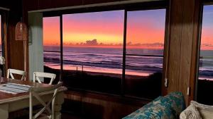 a room with a view of the ocean from a window at Kokomo in Wooli