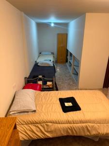 a room with two beds in a room at La Cumbre in Chos Malal +2 photos