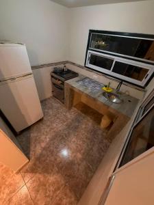 an overhead view of a kitchen with a sink and refrigerator at La Cumbre in Chos Malal