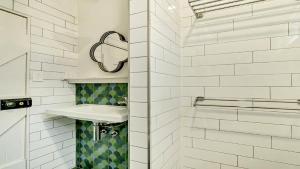 a white bathroom with a sink and a shower at Moomba On Main in Wooli