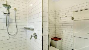 a white bathroom with a shower and a toilet at Moomba On Main in Wooli