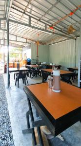 a group of tables in a room with tables and benches at Secret Garden Inn in Tagum