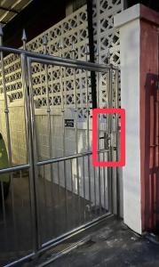 a metal gate with a red sign on it at 9 mins to BTS Private King share Bathroom Kitchen in Amphoe Phra Khanong